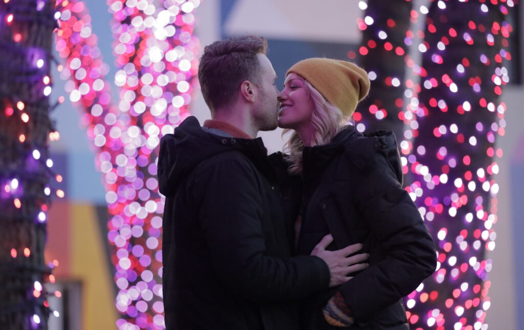 Couple in front of Pandora Christmas lights, Photo Credit: Knack Factory