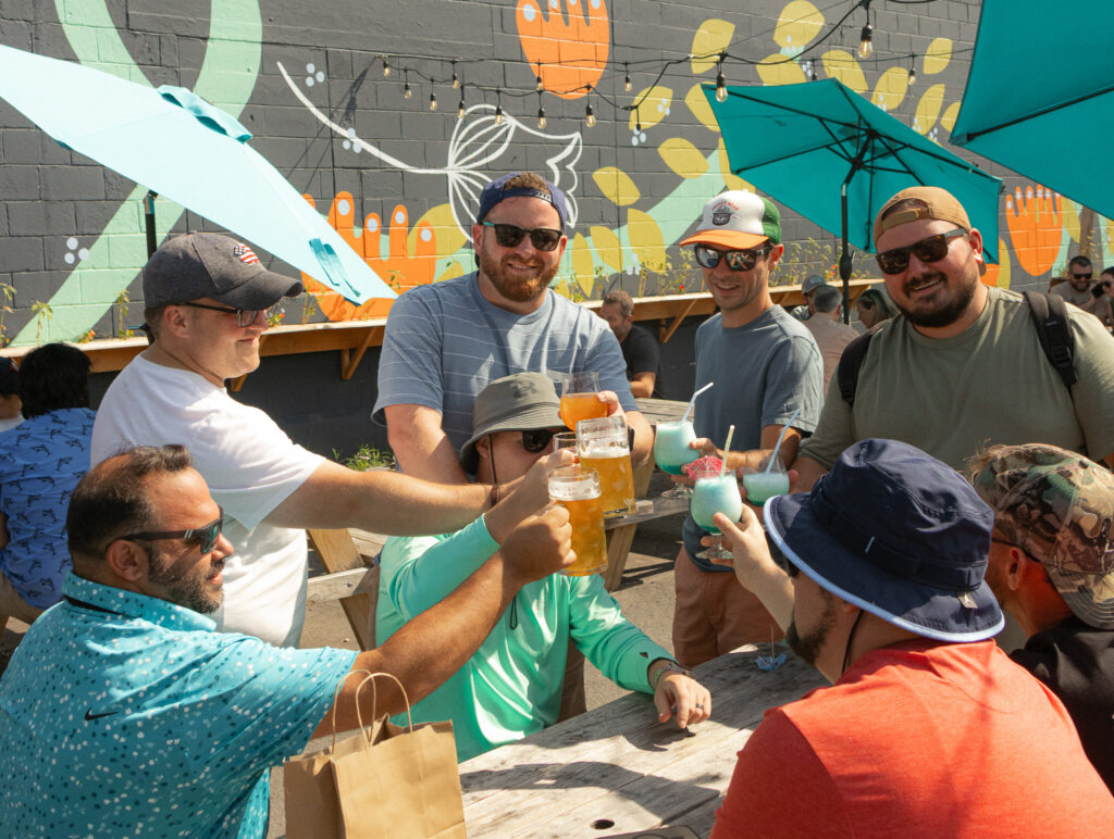 People Cheers-ing at Belleflower Brewing Co. Photo credit: Caylin Lee Photography 